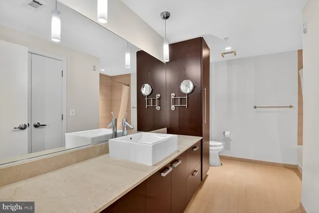 a spacious bathroom with a tub shower and sink