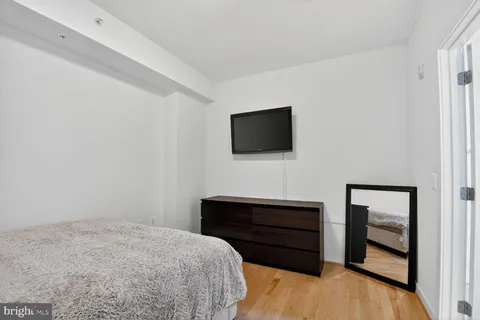 a bedroom with a bed and a flat screen tv