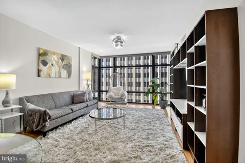 a living room with furniture lamp and rug