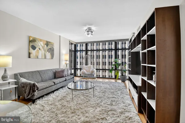 a living room with furniture lamp and rug
