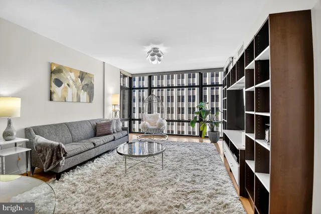 a living room with furniture lamp and rug