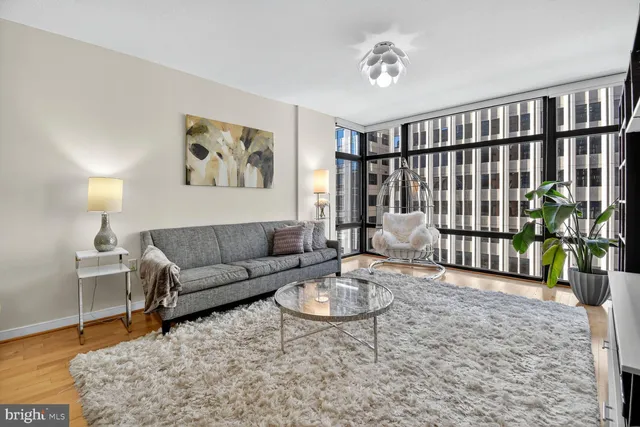 a living room with furniture and wooden floor