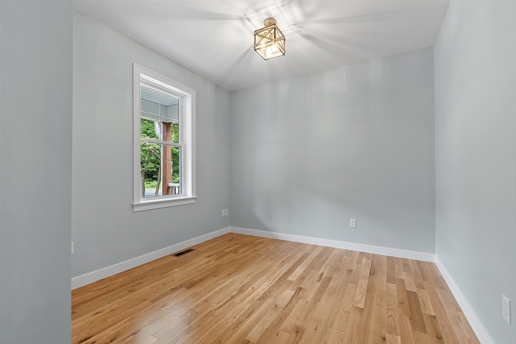 94 Fitchburg Road, Unit 3 Townsend, MA 01469 - Photo 20 of 37 wooden floor in an empty room with a window