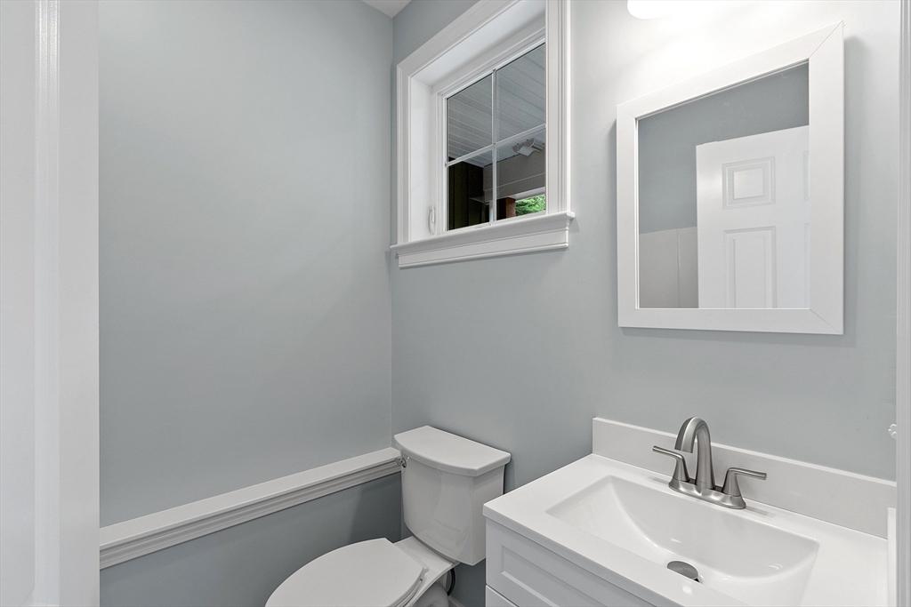 94 Fitchburg Road, Unit 3 Townsend, MA 01469 - Photo 23 of 37 a bathroom with a toilet a sink and mirror