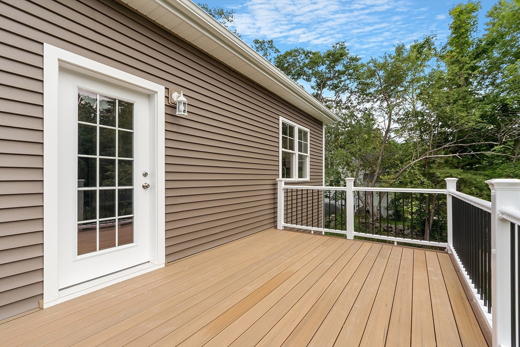 94 Fitchburg Road, Unit 3 Townsend, MA 01469 - Photo 29 of 37 a view of backyard with wooden floor and fence