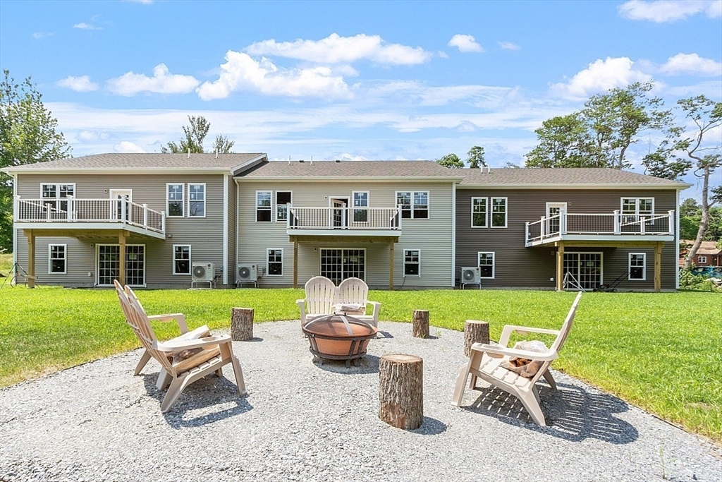 94 Fitchburg Road, Unit 3 Townsend, MA 01469 - Photo 35 of 37 a view of a house with backyard sitting area and garden