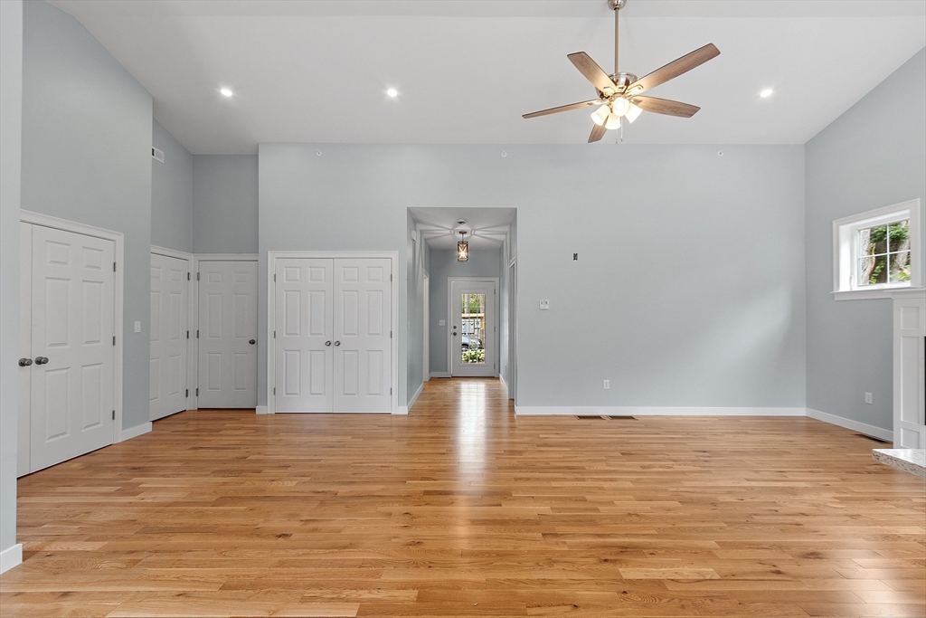 94 Fitchburg Road, Unit 3 Townsend, MA 01469 - Photo 8 of 37 a view of an empty room with window and wooden floor