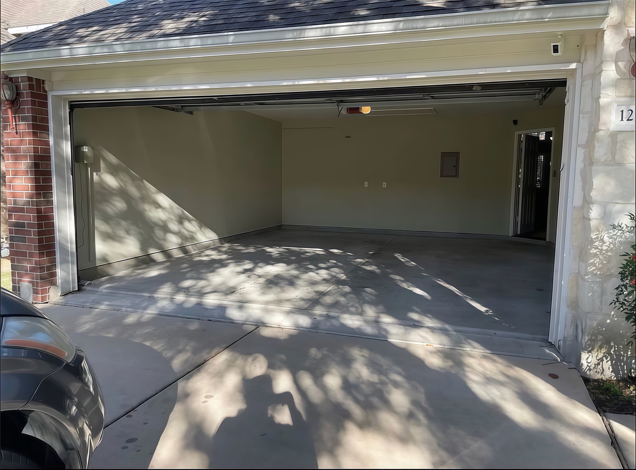 12616 Alberta Ridge Trail Austin, TX 78726 - Photo 13 of 26 Smooth concrete floors and a wide entry door highlight this functional garage space.