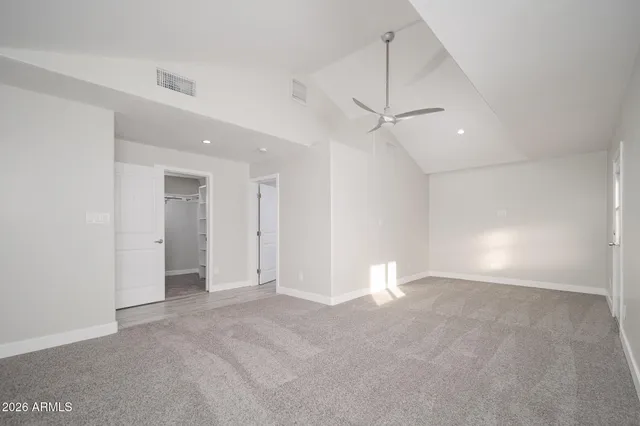 an empty room with fan and a ceiling fan