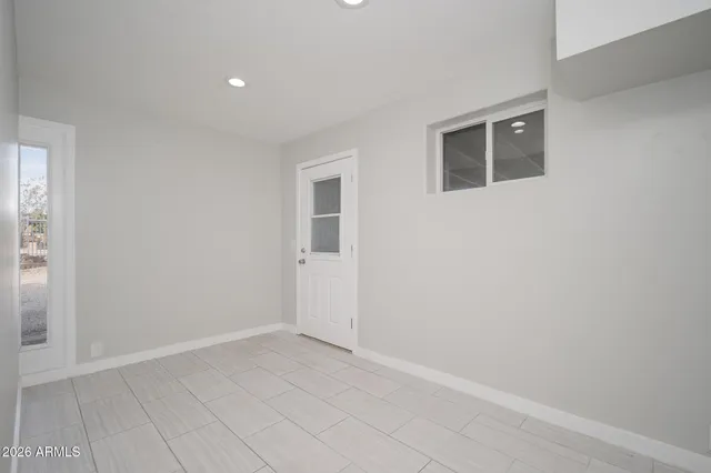 a view of an empty room with windows