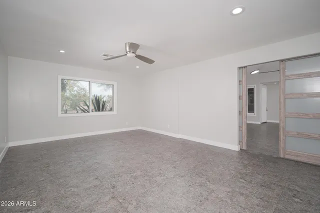 an empty room with windows and closet