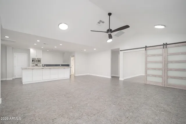 a view of an empty room with a kitchen