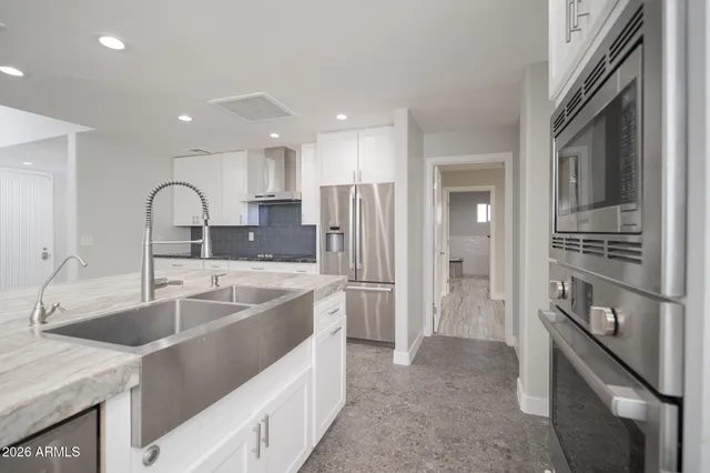 a kitchen with a sink cabinets and stainless steel appliances