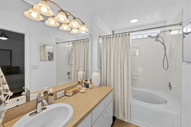 a bathroom with a sink a tub and a mirror