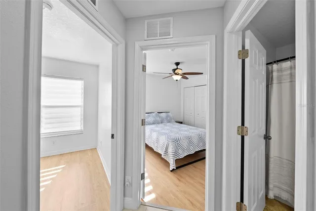 a bathroom with a granite countertop sink a mirror and shower