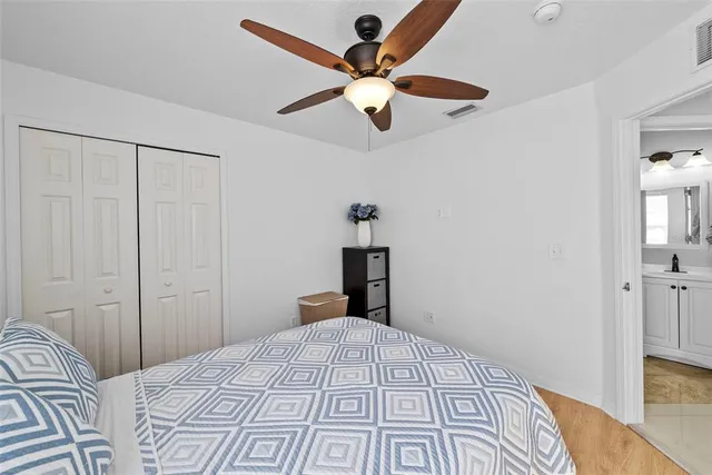 a bedroom with a large bed and a chandelier
