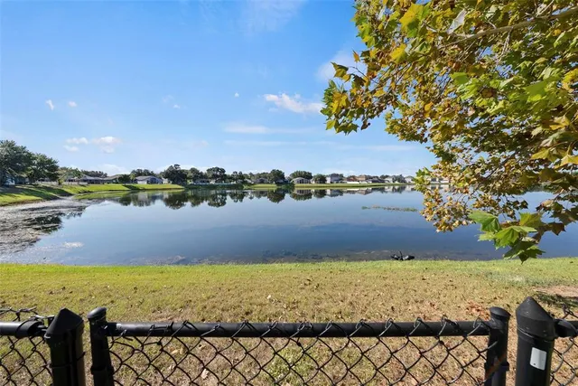 a view of a house with pool and chairs