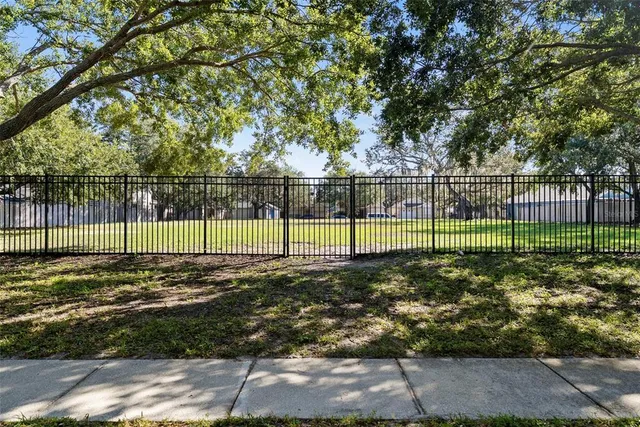 a view of outdoor space with green field and trees
