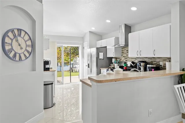 a kitchen with stainless steel appliances granite countertop a refrigerator and a stove top oven