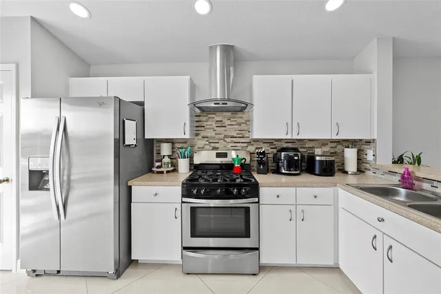 a kitchen with refrigerator and stove