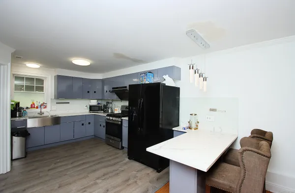 a kitchen with stainless steel appliances granite countertop a refrigerator and a stove top oven