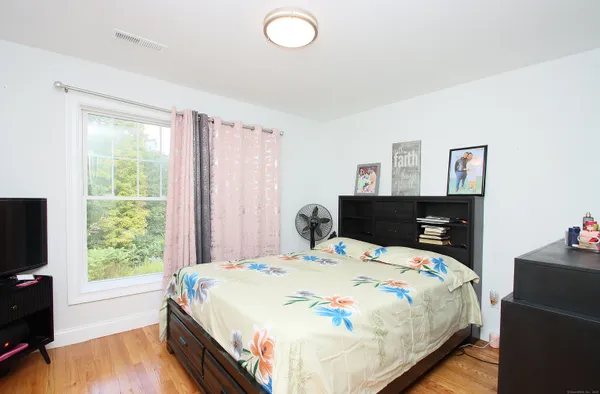 a bedroom with a bed and a large window