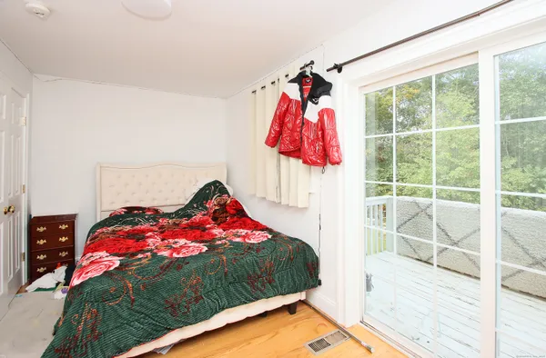 a bedroom with a bed and a large window