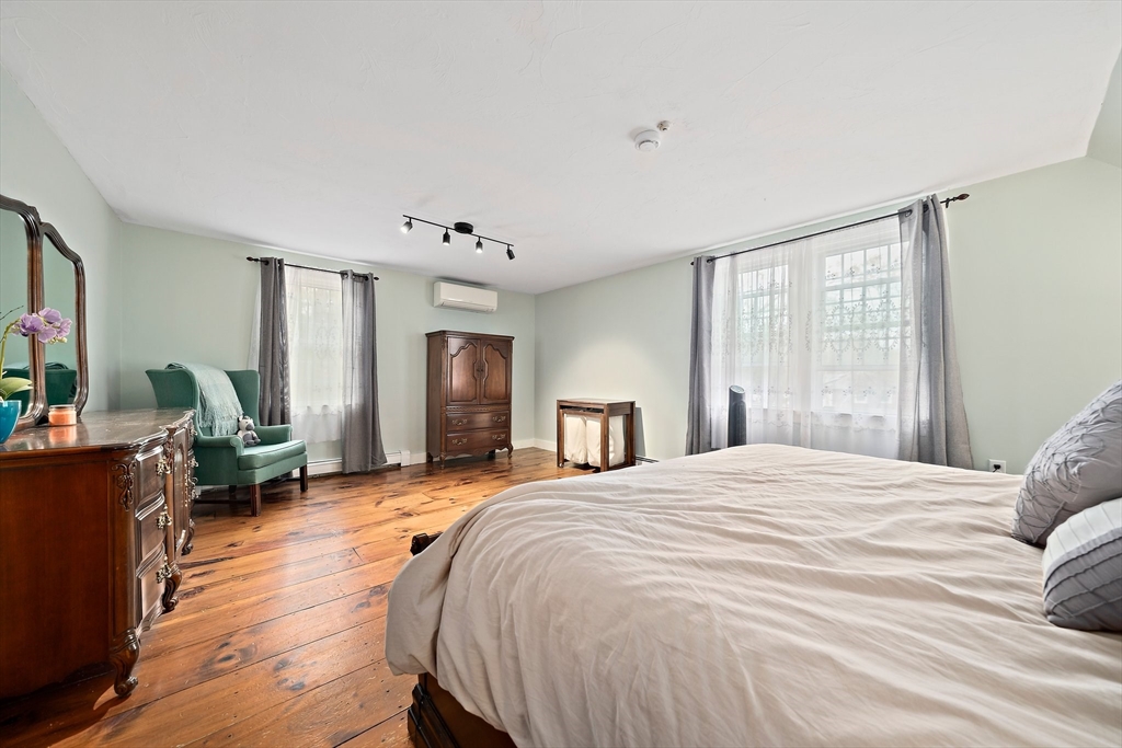 372 Winter Street Walpole, MA 02081 - Photo 19 of 42 a spacious bedroom with a bed and wooden floor