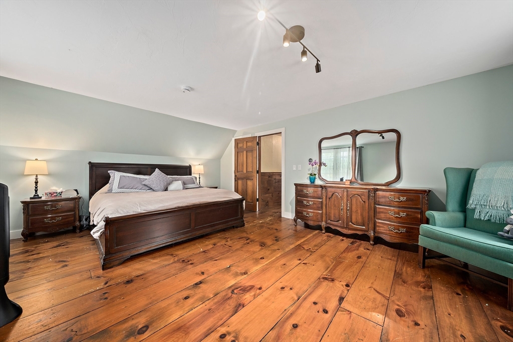 372 Winter Street Walpole, MA 02081 - Photo 20 of 42 a spacious bedroom with a bed a couch and dresser