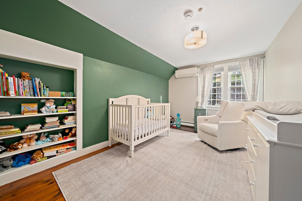 372 Winter Street Walpole, MA 02081 - Photo 21 of 42 a living room with furniture and a book shelf