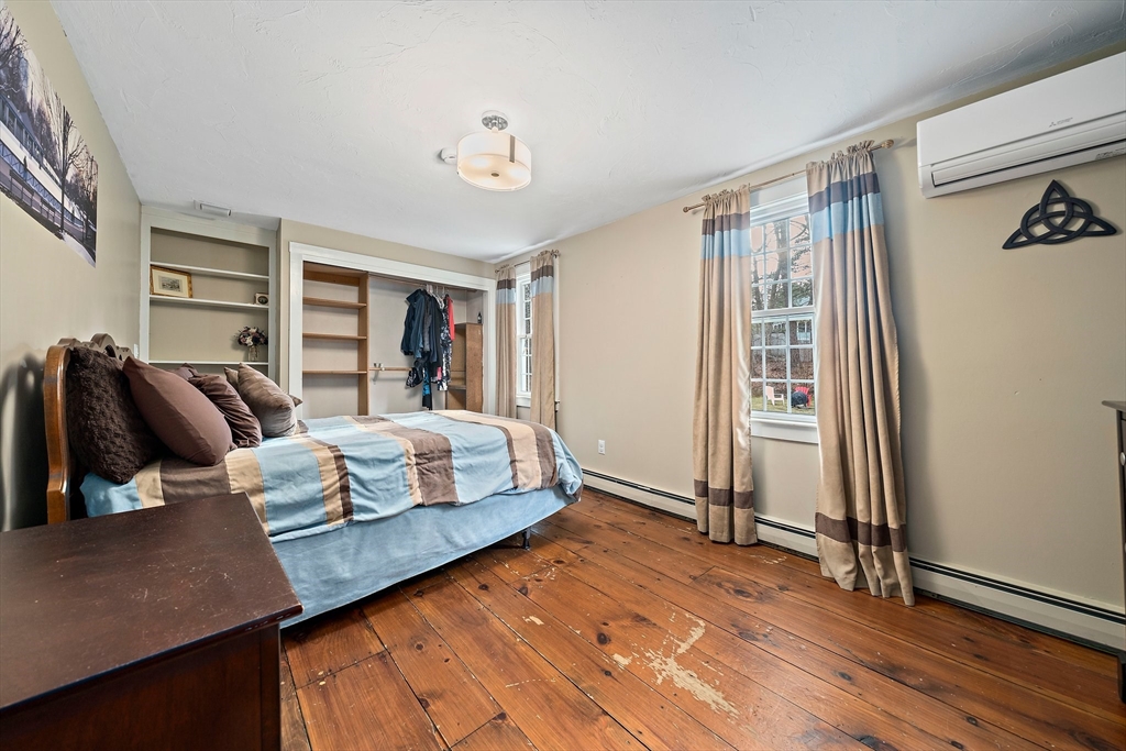 372 Winter Street Walpole, MA 02081 - Photo 22 of 42 a bedroom with a bed and wooden floor