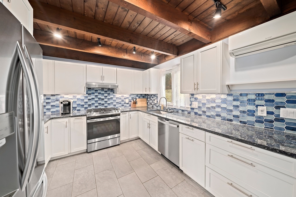 372 Winter Street Walpole, MA 02081 - Photo 4 of 42 a kitchen with stainless steel appliances granite countertop a sink and cabinets