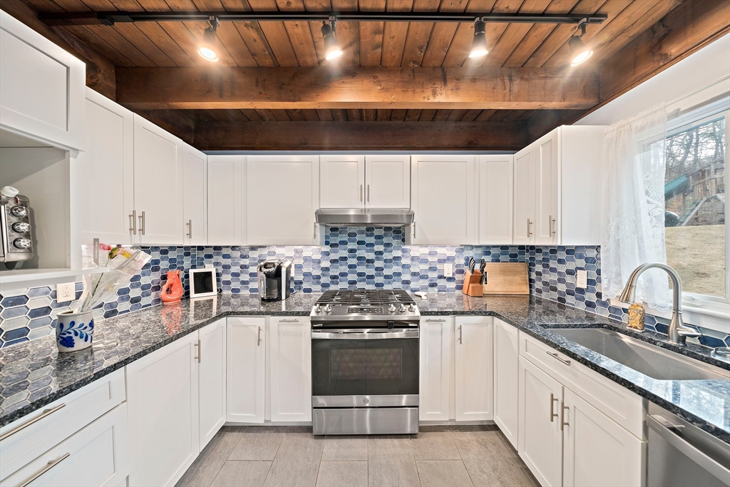 372 Winter Street Walpole, MA 02081 - Photo 6 of 42 a kitchen with a white cabinets and white appliances