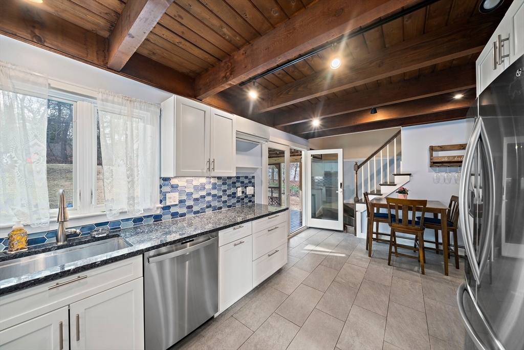 372 Winter Street Walpole, MA 02081 - Photo 7 of 42 a large white kitchen with a large window