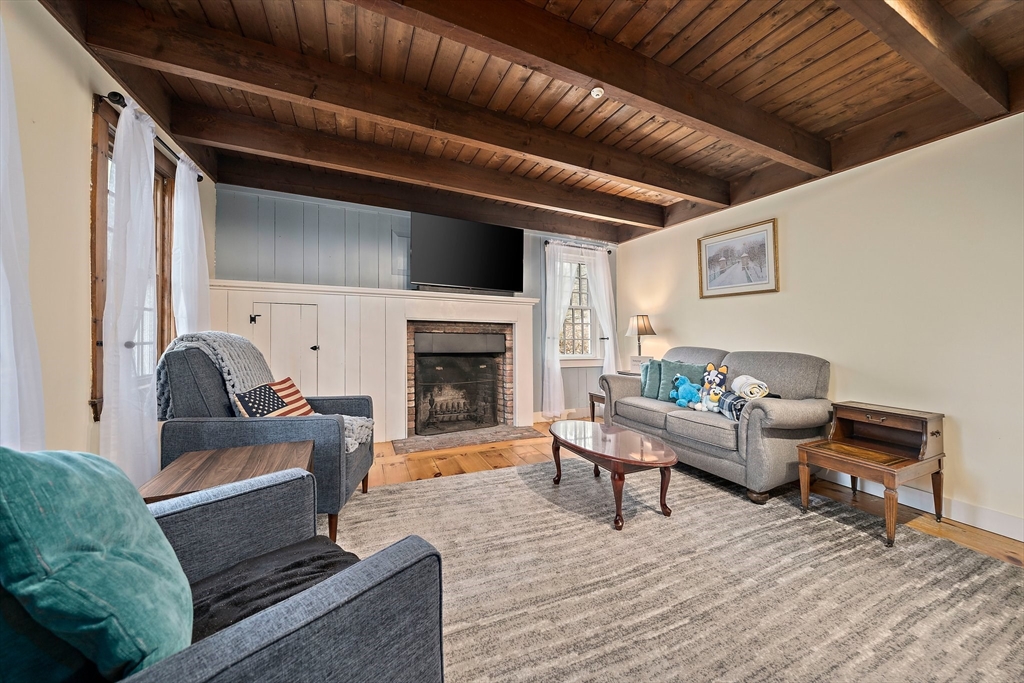372 Winter Street Walpole, MA 02081 - Photo 10 of 42 a living room with furniture and a fireplace