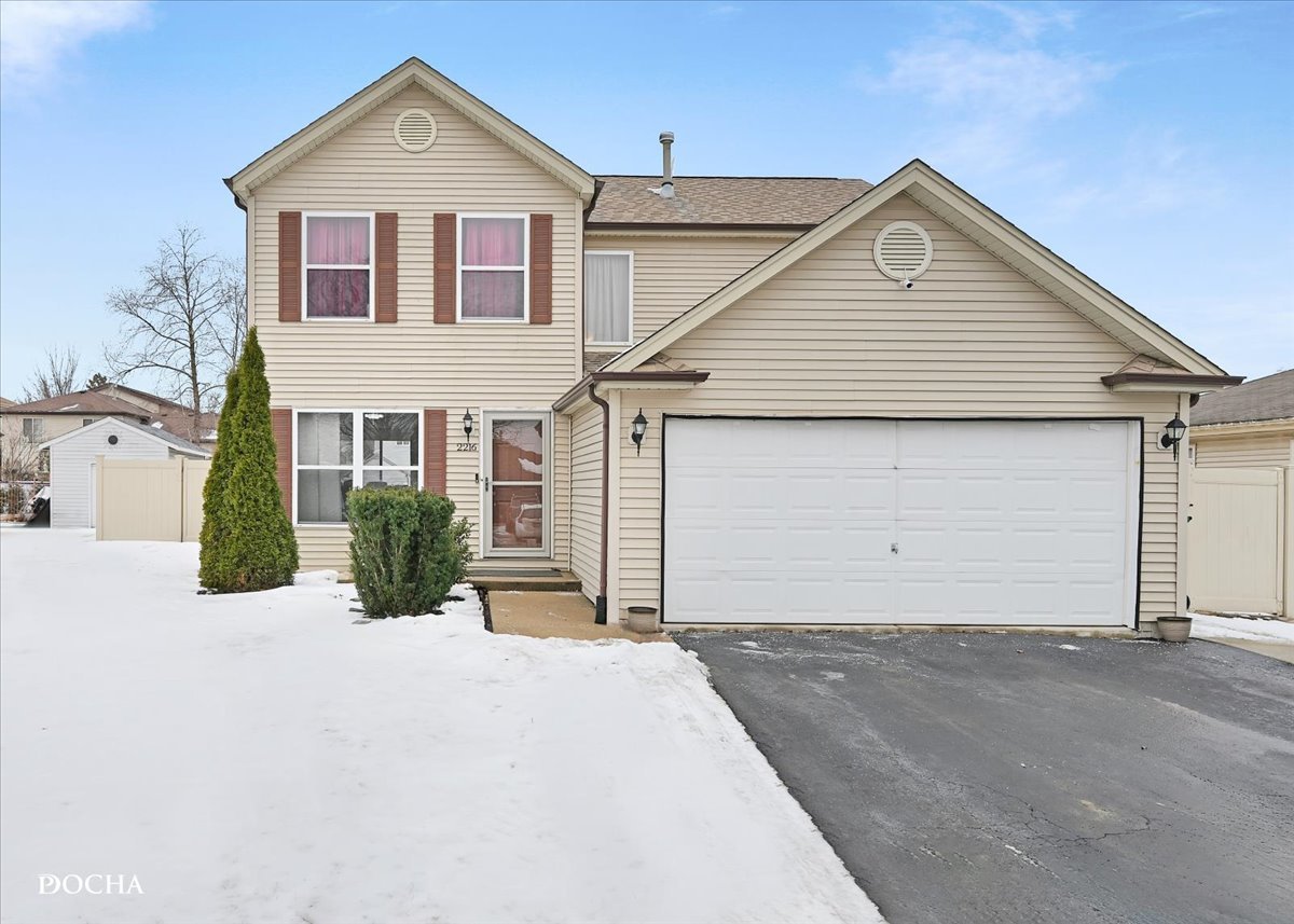 2216 Beechwood Road Joliet, IL 60432 - Photo 1 of 21 a front view of a house with a yard and garage