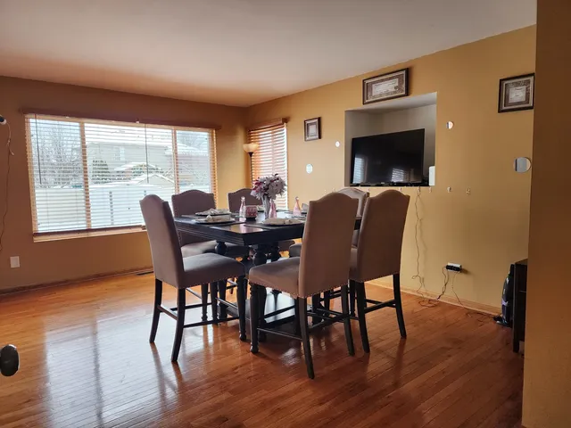 a view of a dining room with furniture and wooden floor