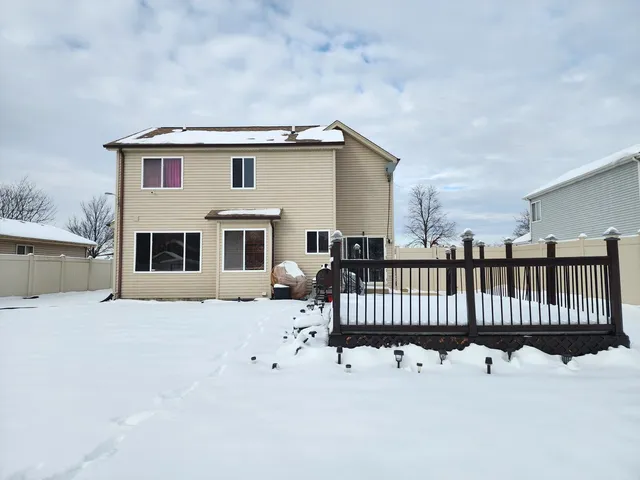 a view of a house with a bench in front of house