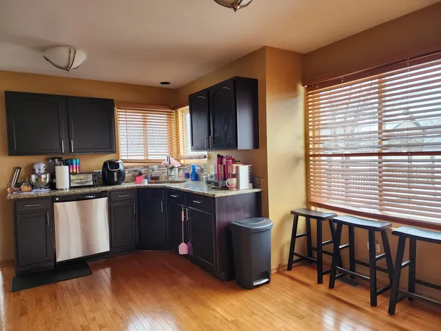 a kitchen with a sink cabinets and window