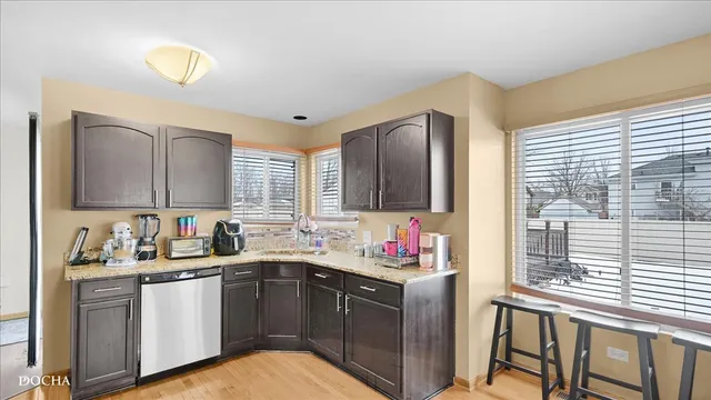 a bathroom with a granite countertop toilet sink and mirror
