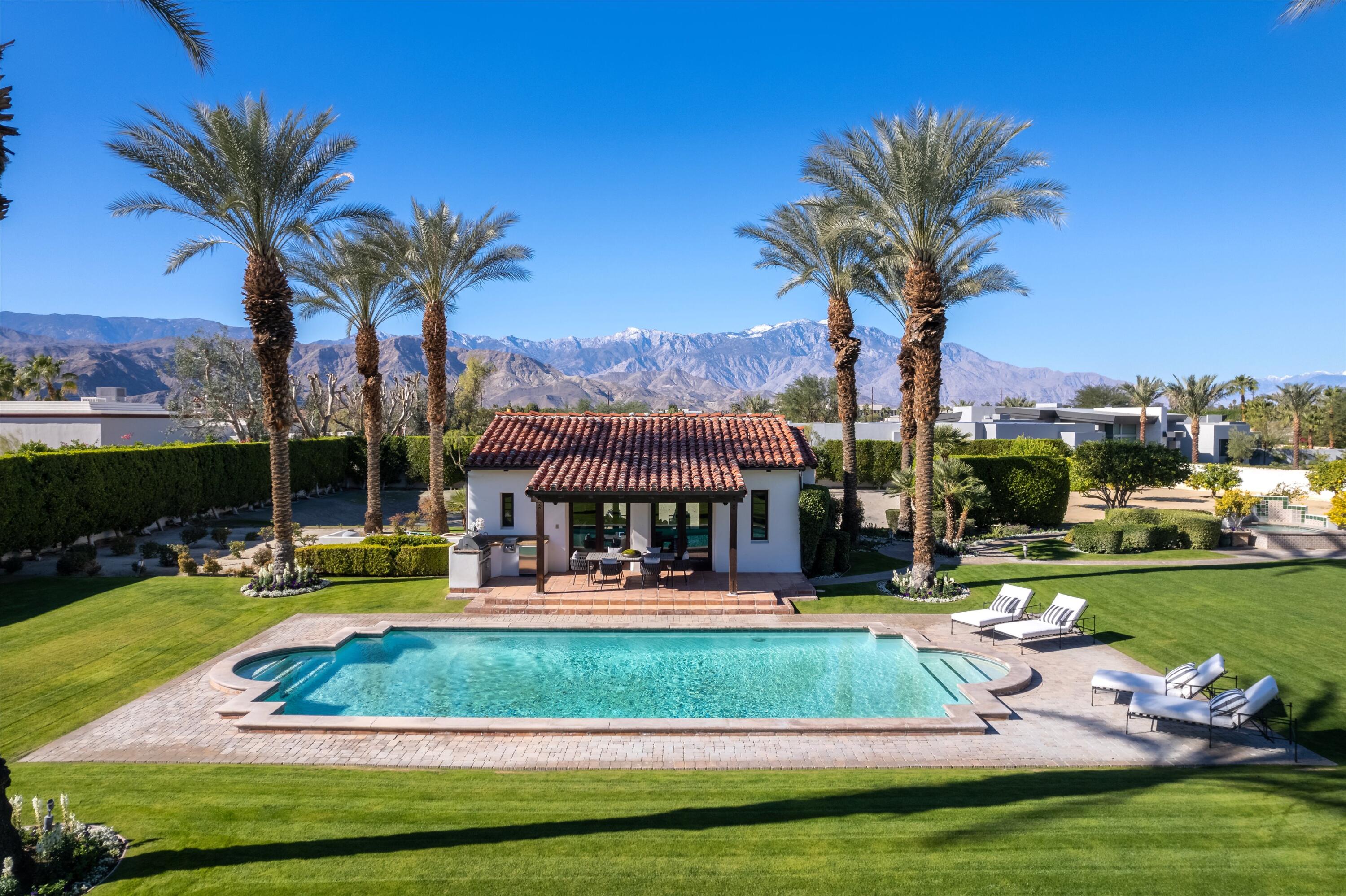 2 Serrano Way Rancho Mirage, CA 92270 - Photo 12 of 76 a view of a swimming pool with a table and chairs