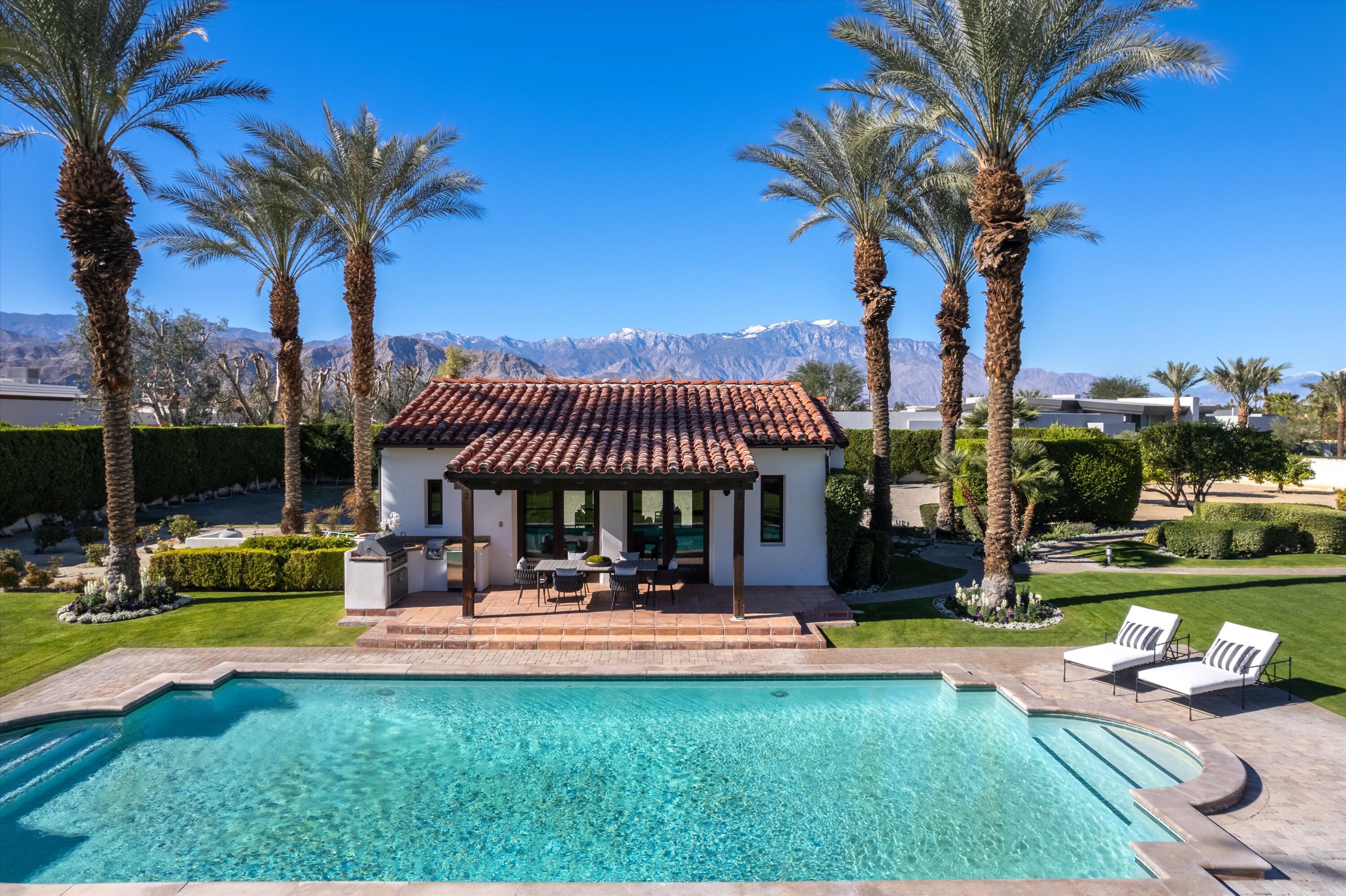 2 Serrano Way Rancho Mirage, CA 92270 - Photo 13 of 76 a view of a swimming pool with a table and chairs