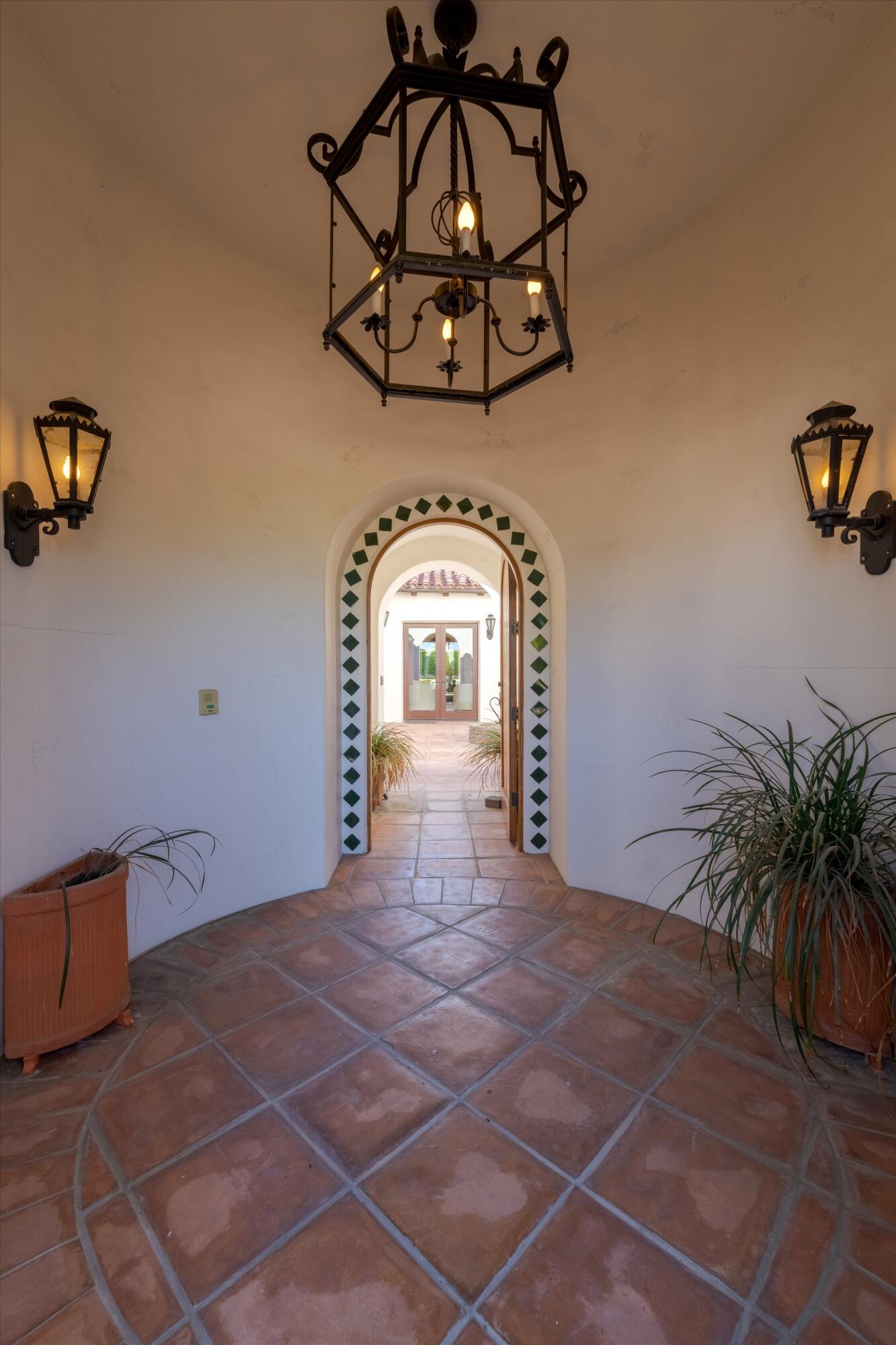 2 Serrano Way Rancho Mirage, CA 92270 - Photo 20 of 76 a view of a livingroom with a chandelier and glass door