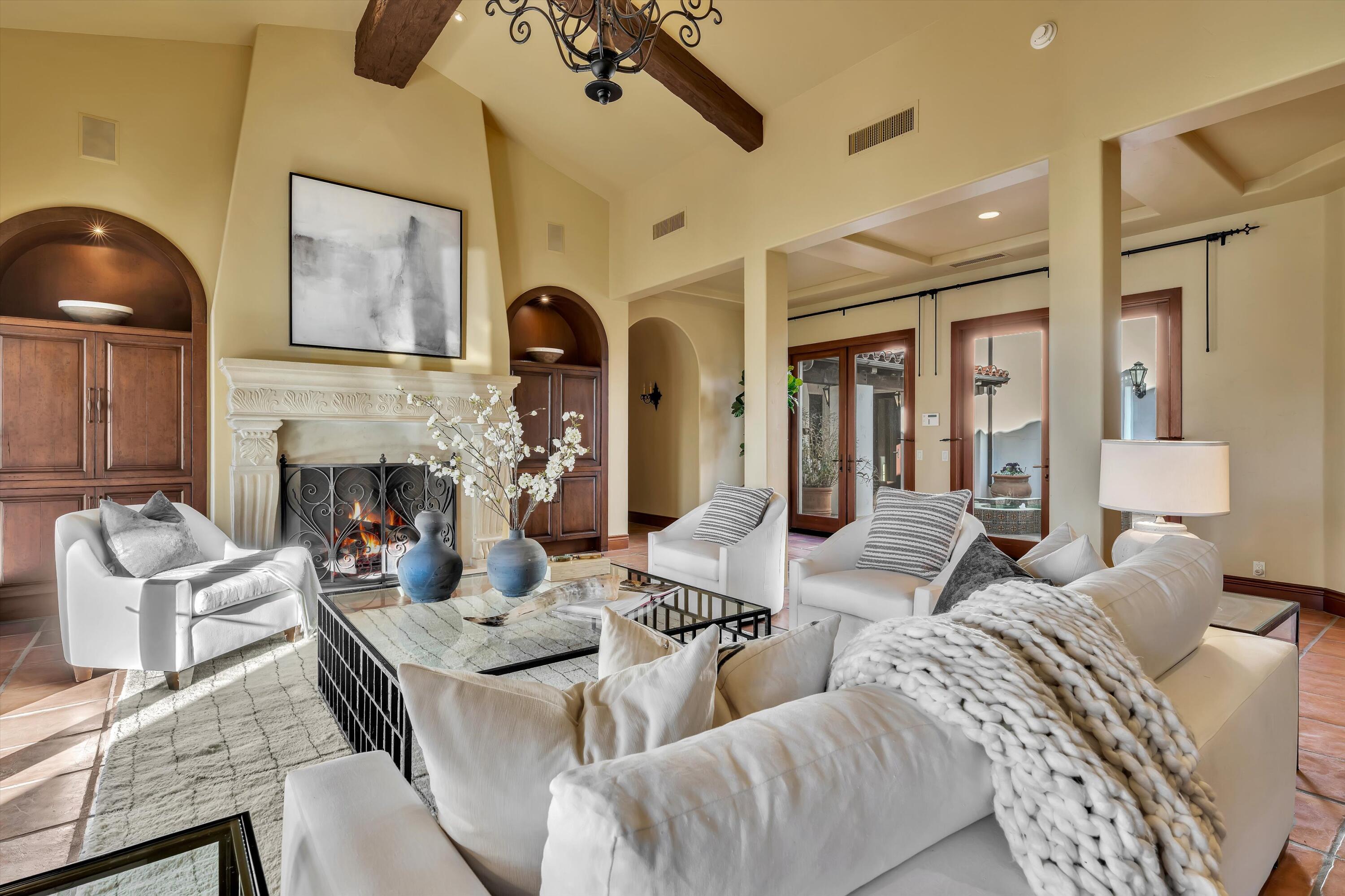 2 Serrano Way Rancho Mirage, CA 92270 - Photo 37 of 76 a living room with furniture and a fireplace