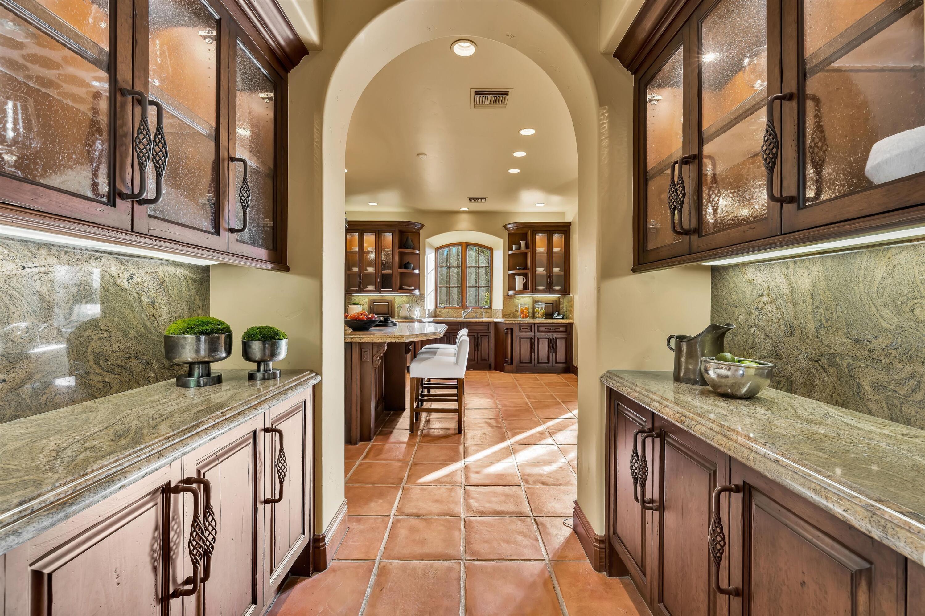 2 Serrano Way Rancho Mirage, CA 92270 - Photo 40 of 76 a kitchen with stainless steel appliances granite countertop a sink and cabinets