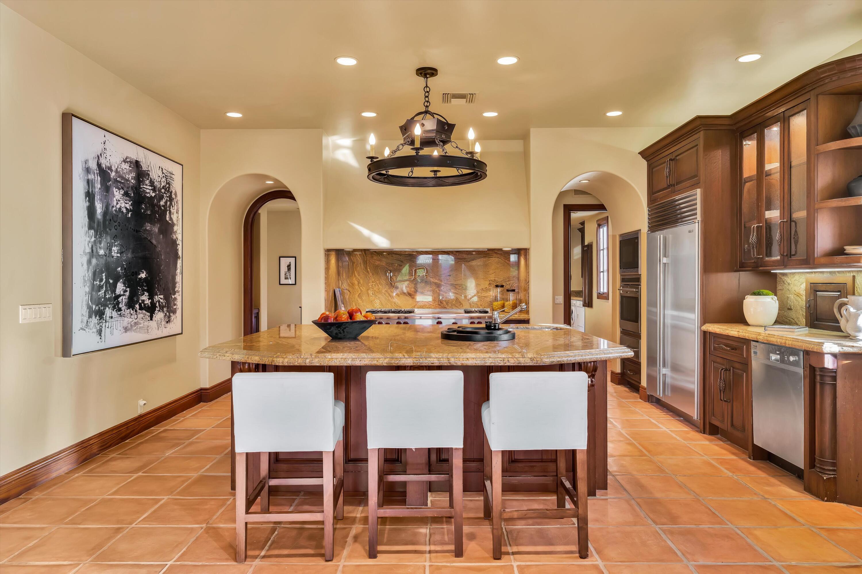 2 Serrano Way Rancho Mirage, CA 92270 - Photo 46 of 76 a dining room with stainless steel appliances furniture a chandelier and kitchen view