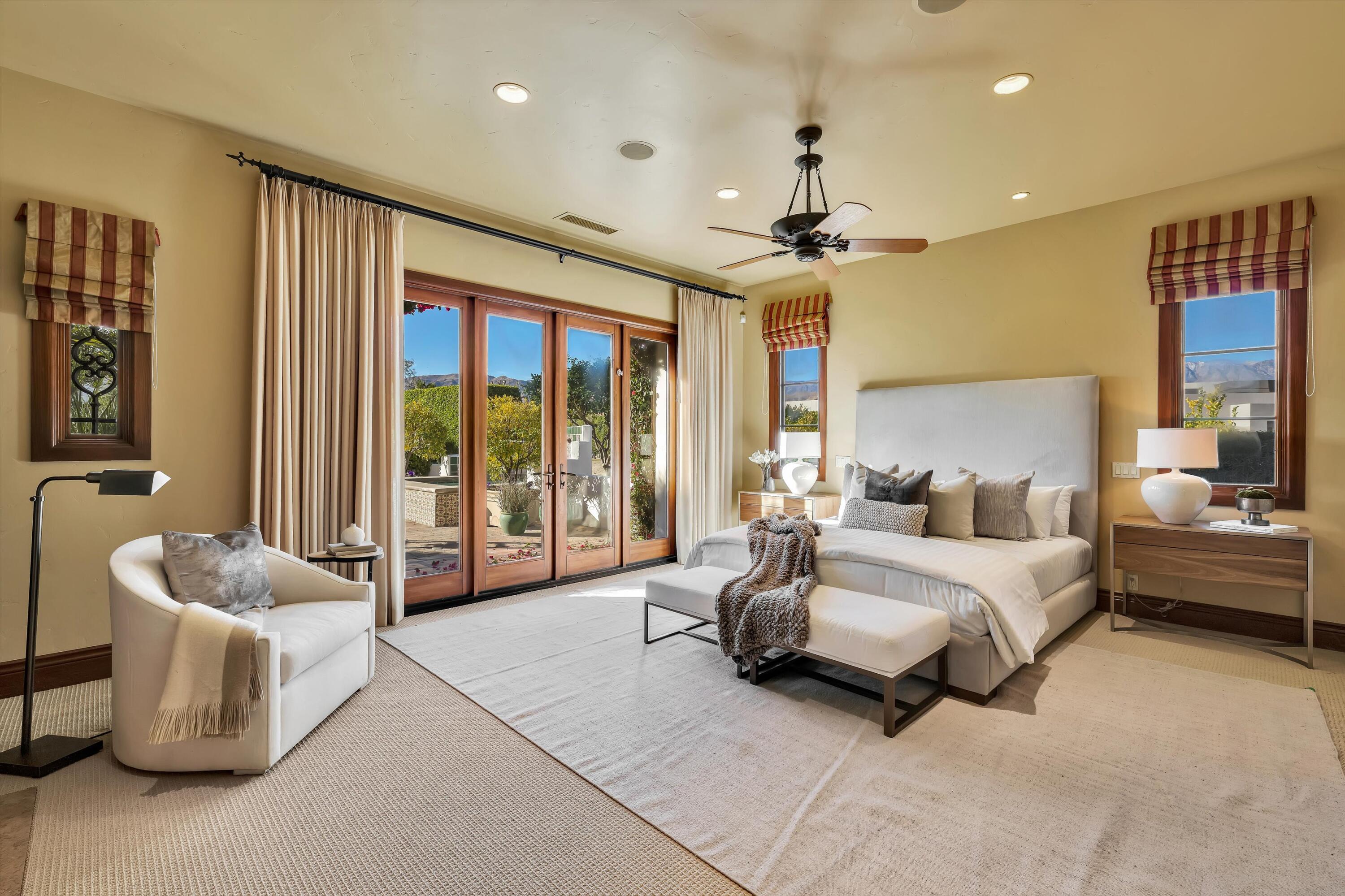 2 Serrano Way Rancho Mirage, CA 92270 - Photo 56 of 76 a spacious bedroom with a bed and glass walk in closet