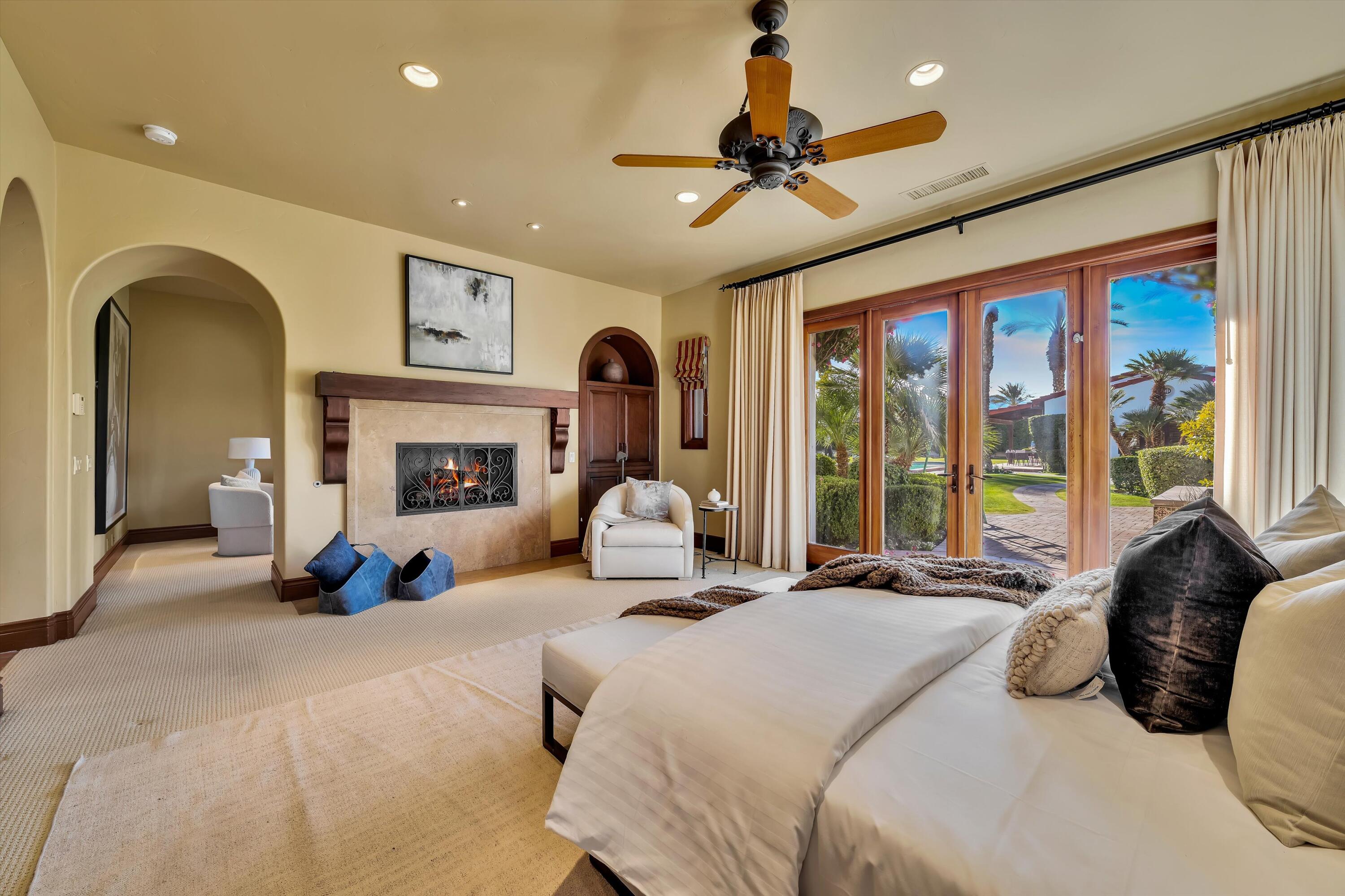 2 Serrano Way Rancho Mirage, CA 92270 - Photo 57 of 76 a bedroom with a bed window and a fireplace