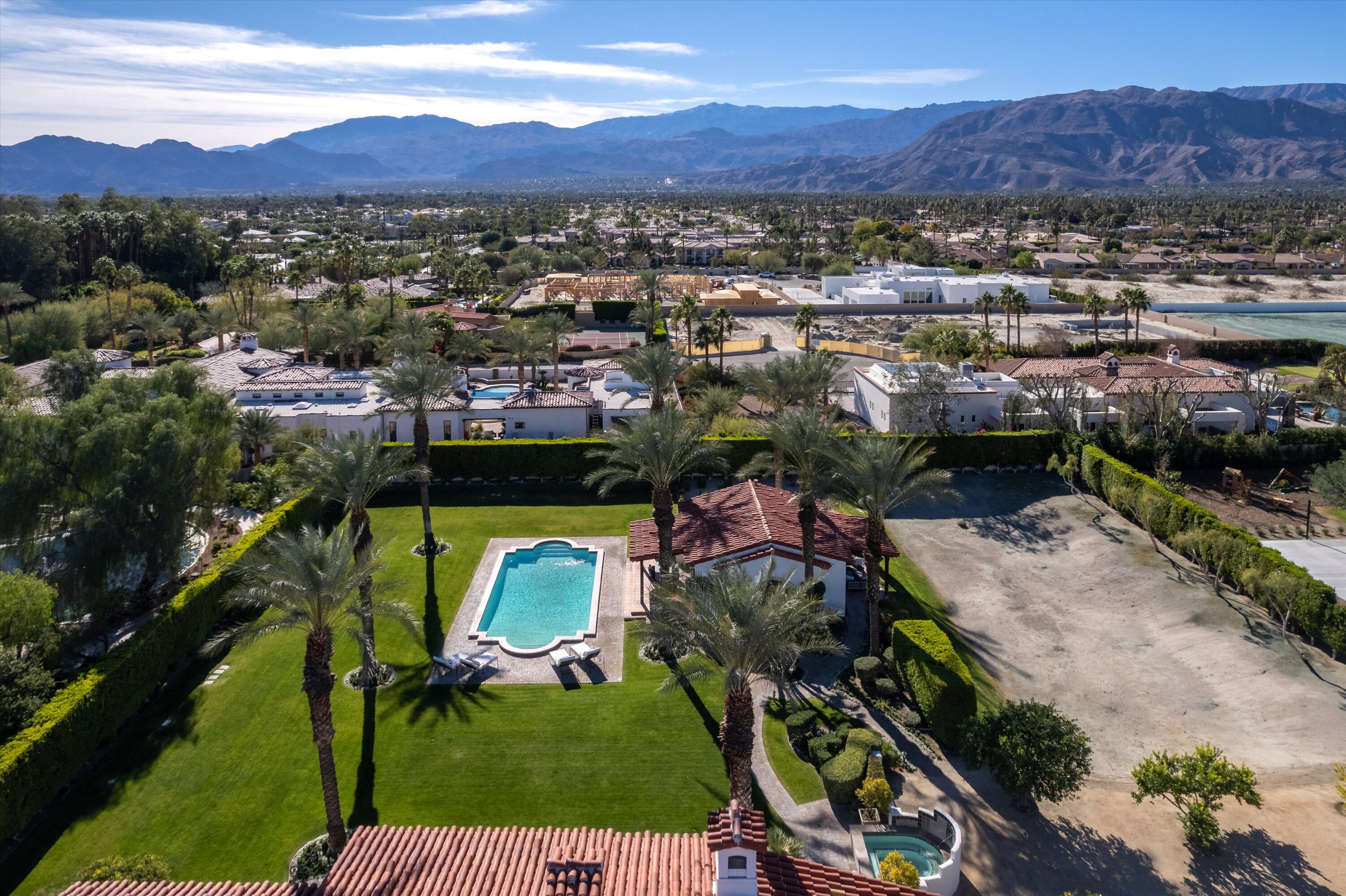 2 Serrano Way Rancho Mirage, CA 92270 - Photo 6 of 76 an aerial view of a house with a garden and mountains