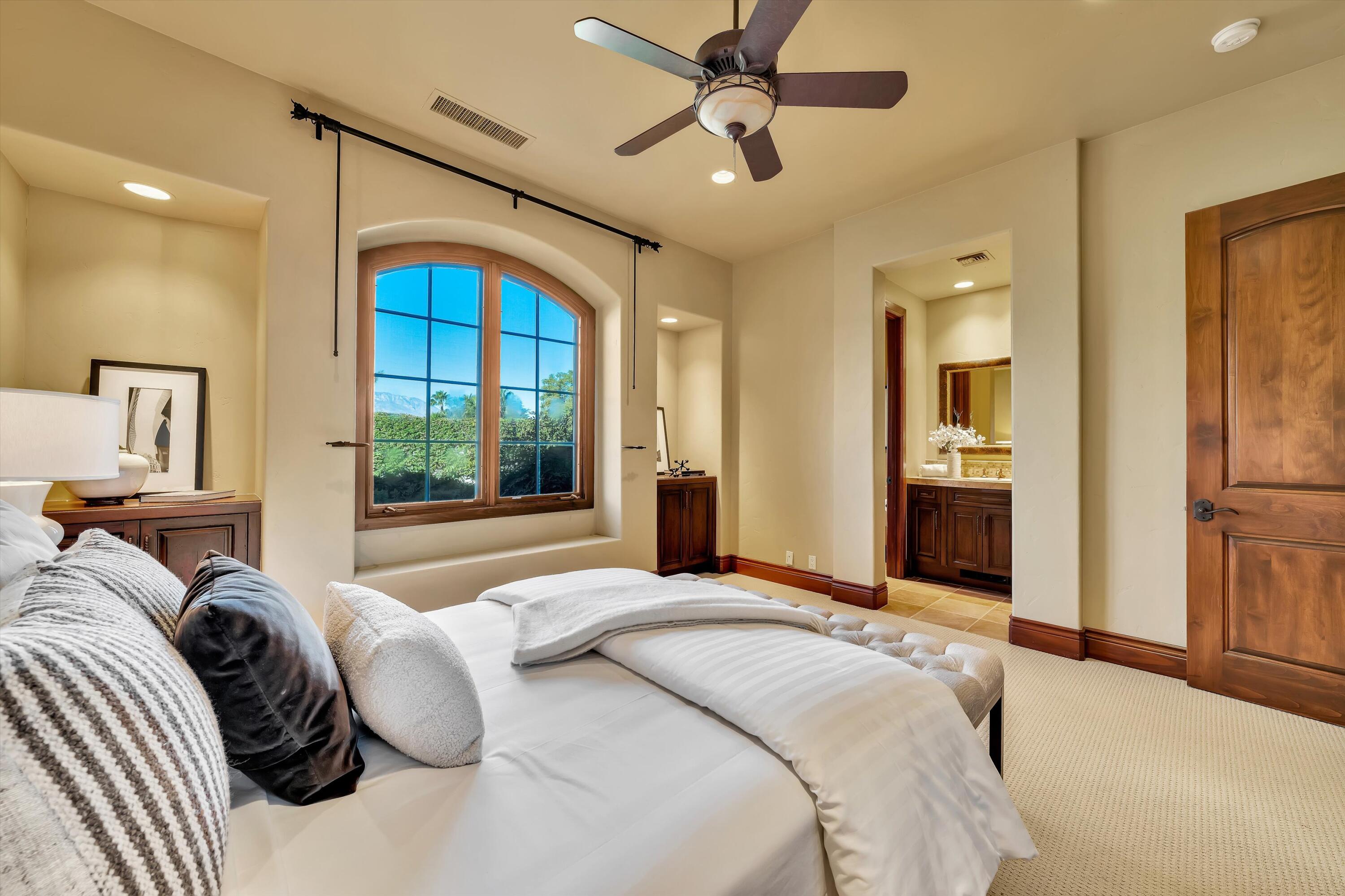 2 Serrano Way Rancho Mirage, CA 92270 - Photo 61 of 76 a bedroom with a large bed and a window